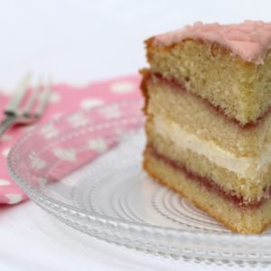 Victoria sponge with seedless raspberry jam, vanilla bean buttercream, and icing flavoured and coloured with fresh strawberry juice. 

[Food made and photographed by Laura Donohue, Cottage Garden Cookery]