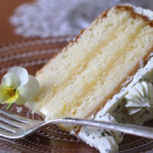 Homemade lemon curd makes a luscious filling to this light, moist, layer cake.  Poppyseeds in the buttercream icing add an appealing texture and made it less sweet and more interesting.  

[Food made and photographed by Laura Donohue, Cottage Garden Cookery]