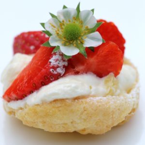 Airy scone with chantilly cream and fresh strawberry and strawberry flower from the garden. Laura's scones are made with cream and a light touch, so melt in the mouth.

[Food made and photographed by Laura Donohue, Cottage Garden Cookery]